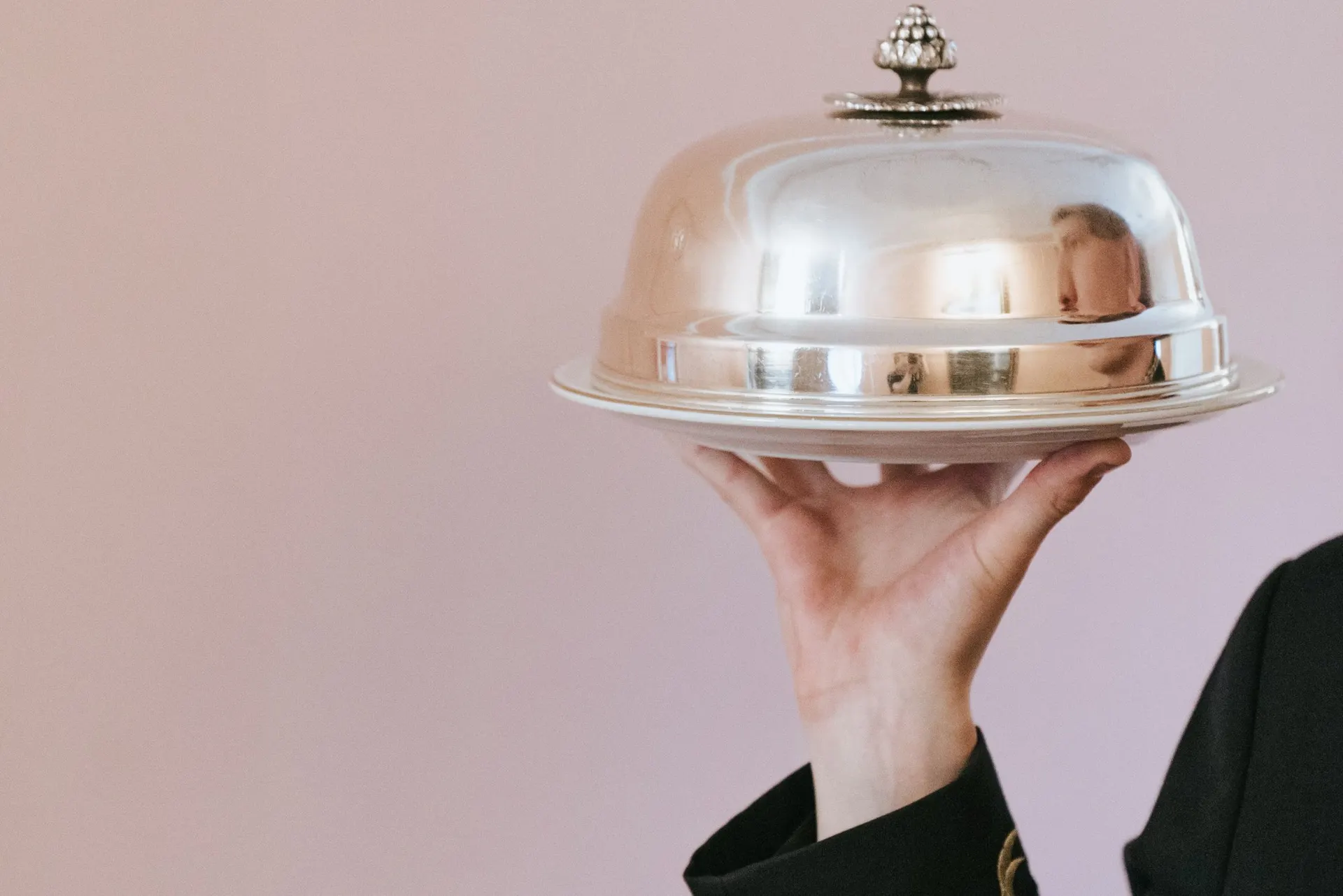 A plated course carried under a silver cloche