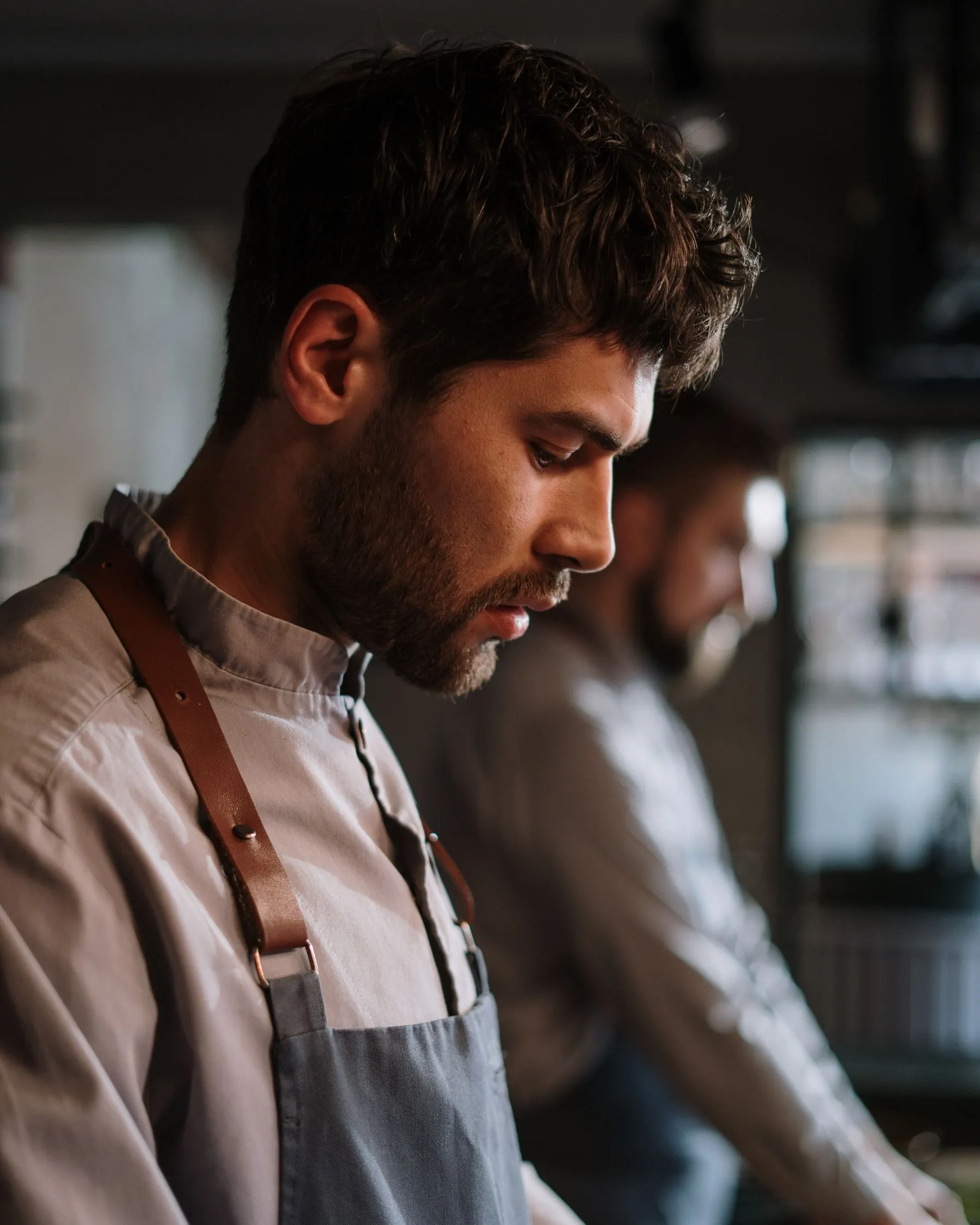 Chef Andrés Vidal photographed in profile in a working kitchen