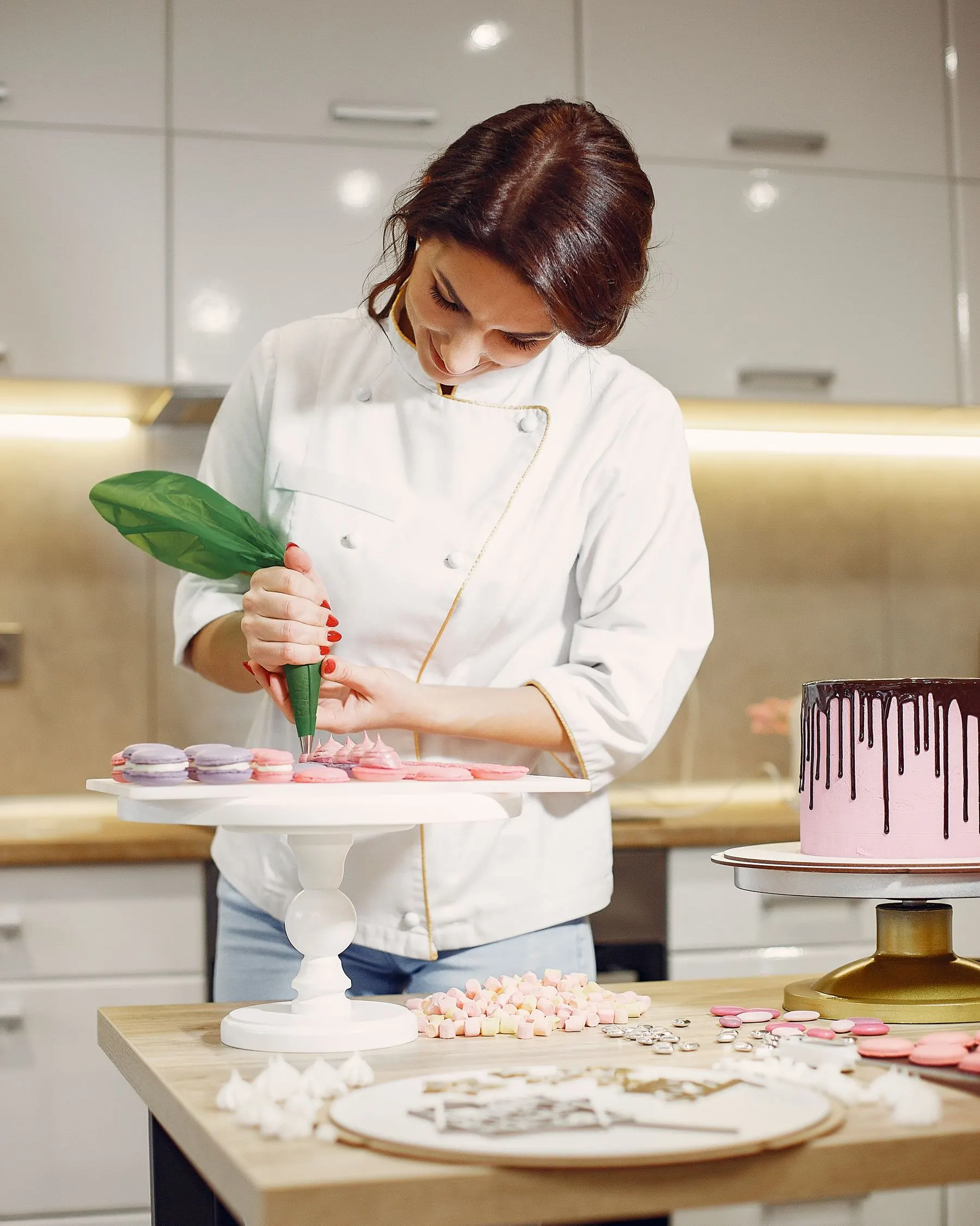 Pastry chef Claire Laurent piping a dessert in a pastry kitchen