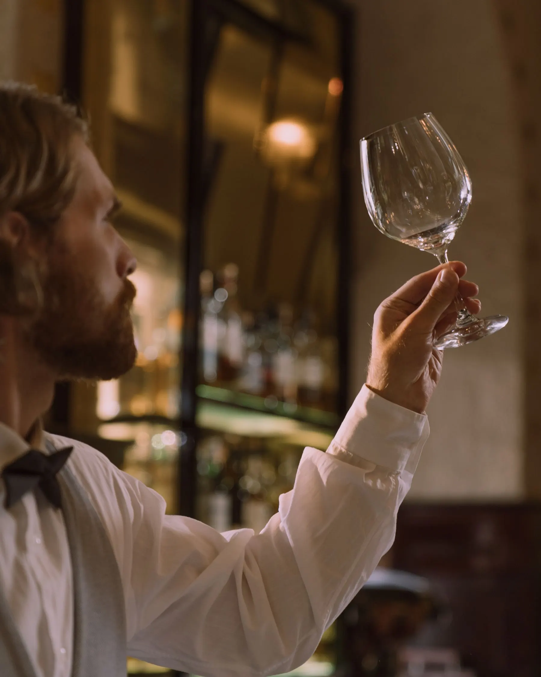 Sommelier Victor Almeida examining a glass of wine